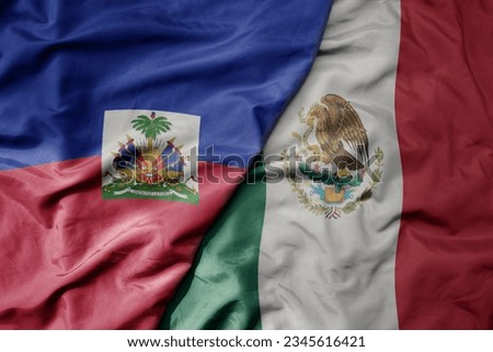 big waving realistic national colorful flag of haiti and national flag of mexico . macro