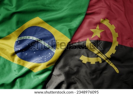 big waving realistic national colorful flag of brazil and national flag of angola . macro