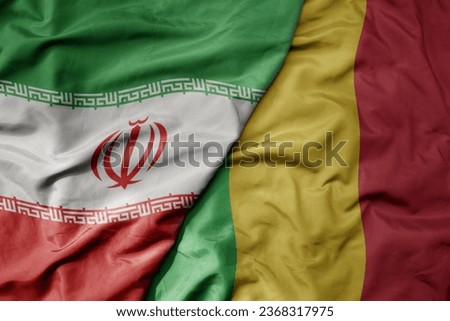big waving realistic national colorful flag of iran and national flag of mali . macro
