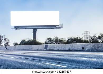 Big white billboard on highway.