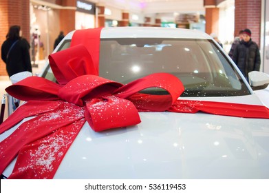 Big White Car With A Big Red Bow