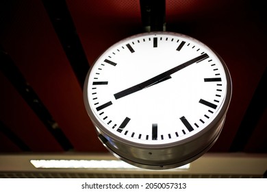 Big white clock in train station or subway station or airport in dark style. Train station clock close up. Mode of Transport, Subway Train