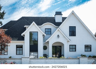 Big white custom made luxury house in the suburbs of Vancouver, Canada. Large family House with nicely landscaped front yard and driveway to garage
