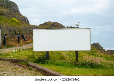 Big White Empty Billboard Mockup With Nature Landscape Background. South Wales, UK.