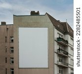 big white or empty billboard on apartment block side wall, your content here, poster mock up.