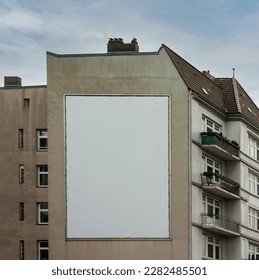 big white or empty billboard on apartment block side wall, your content here, poster mock up.