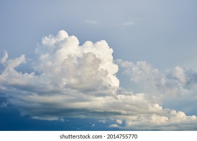 Big White Fluffy Clouds On Clear Blue Sky. Cloudy Sky Background With Copy Space. Cumulus Cloud Close Up