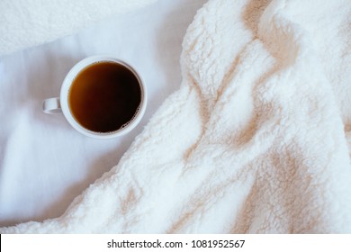 Big White Morning Cup Of Coffee In Bed With Pillow And Cosy Blanket.