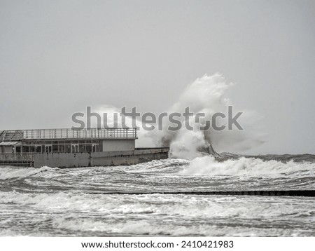Big winter stormy waves of Baltic Sea hitting the pier, Kolobrzeg, Poland