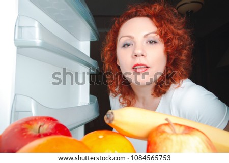 Similar – A hungry woman looks in the fridge