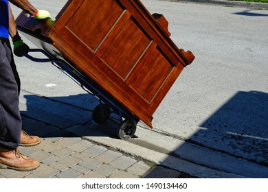 Big Wooden Desk On Trolly Being Moved Onto Street 