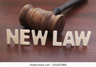 Big Words NEW LAW And Judge Gavel On Table. New Laws Comming And Legal Reform Concept.