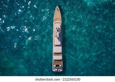 Big Yacht For Millionaires In The Sea Drone View. Luxurious White Mega Yacht On Water In The Reflection Of The Sun Top View. Big White Super Ship In The Ocean Aerial View.