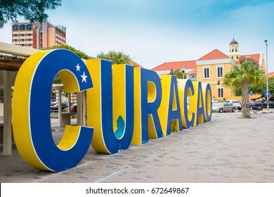 Big Yellow And Blue Curaçao Sign In City Centre.