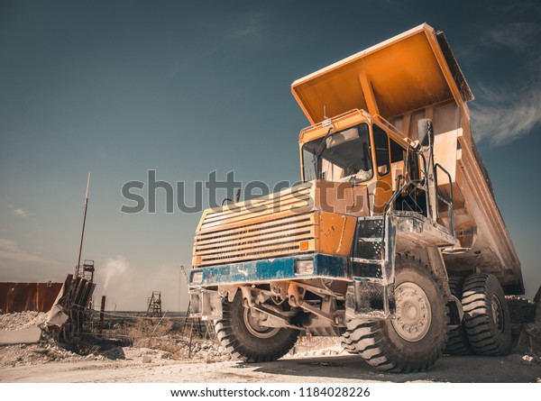 Big Yellow Mining Truck works in\
Quarry as Industrial Background, copy space for text,\
toned