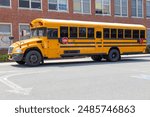 Big Yellow School Bus in front of School Building