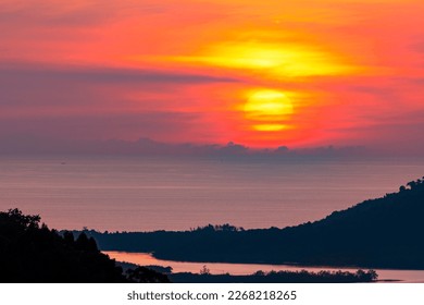 Big yellow sun setting down over sea surface in sunset or sunrise sky,Amazing nature landscape view 