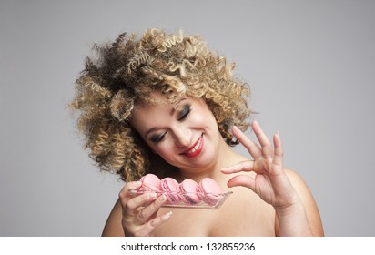 Bigger Woman Holding A Trey With Macarons Trying To Loose Weight But Cheating