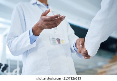 The Biggest Deal In Research And Development. Shot Of Two Unrecognisable Scientists Shaking Hands In A Laboratory.