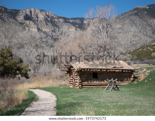Bighorn Canyon National\
Recreation Area, MontanaUSA: April 21, 2018: A log cabin on the\
Ewing-Snell ranch in the Bighorn Canyon National Recreation Area in\
Montana.