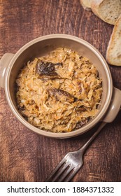 Bigos - Cabbage Stewed With Meat, Dried Mushrooms And Sausage On Old Wooden Background.Traditional Dish Of Polish Cuisine.