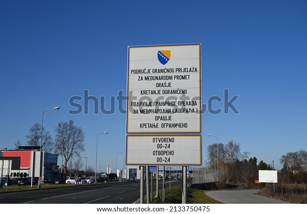 Orašje, BiH, February 2022: Border crossing.\
Board with the coat of arms of BiH. Border between Bosnia and\
Herzegovina and Croatia. Inscription: International border\
crossing. Movement\
restricted.
