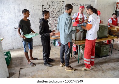 Bihac, BiH, July 07th 2018, Refugees Eating Meal In Camp. Food Distribution For Hungry Migrants. People Standing In Line And Waiting For Food In Migrant Shelter. Balkan Route. Food Line. Bosnia. Syria