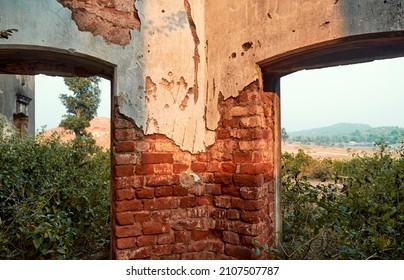 Bihar, 12-11-2021: View of hilly landscape (Chota Nagpur plateau) seen through defaced walls of old Simultala Rajbari (royal mansion). The property is now completely abandoned and gradually decaying.