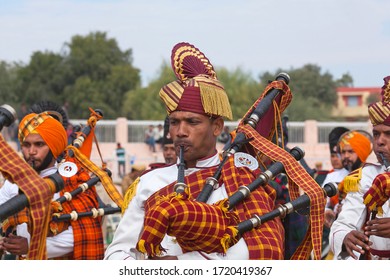 BIKANER, RAJASTHAN, INDIA - JANUARY 11, 2020: Indian military bagpipers band playing bagpipe during Camel festival in Rajasthan state