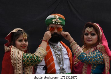 Bikaner, Rajasthan/ india - January11, 2020: Two beautiful young girls posing in Rajasthani youth wearing a mustache wearing a Rajasthani dress and jewelery at Camel Festival Bikaner