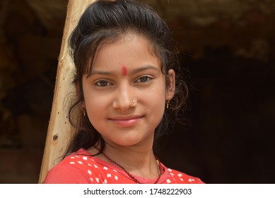 Bikaner, Rajasthan / India-June 03,2020: A beautiful young girl standing under a mud hut in the rural area of ​​Bikaner