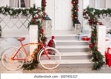 bike decorated with christmas lights at the house porch