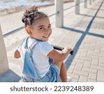 Bike, girl and smile for beach, holiday and outdoor to relax, summer and waterfront. Portrait, cycling and female child enjoy seaside vacation, happy and bicycle for wellness, health and promenade.