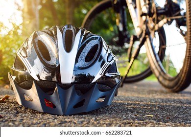 Bike helmet and bike on the street and evening sun