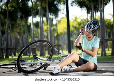 Bike Injuries. Woman Cyclist Fell Off Road Bike While Cycling. Bicycle Accident, Injured Elbow.