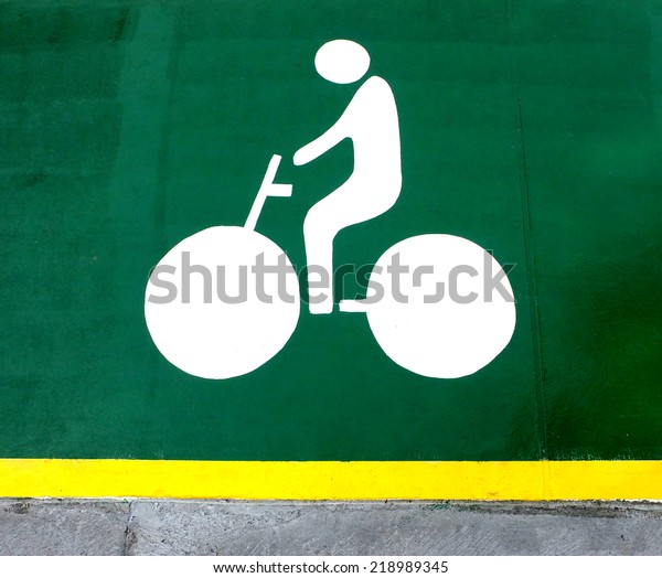 Bike lane and\
bike symbol on green\
footpath.