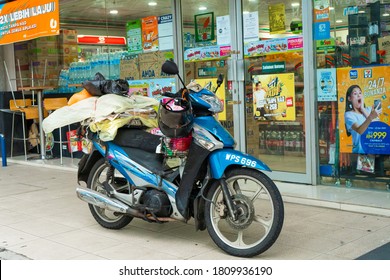 Bike loaded with things. Transport in Asia. Transportation of goods on a bike. Kuala Lumpur / Malaysia - 04.27.2020