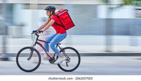 Bike messenger courier delivering in city with motion blur