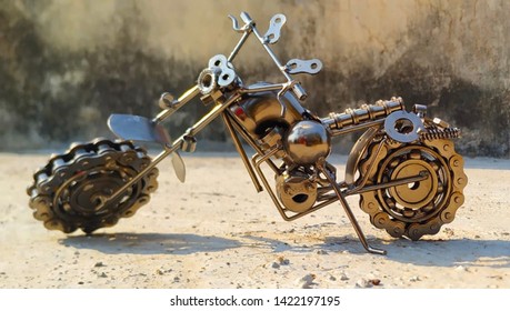 Bike Model made of scrap materials, Small Metal motorbike made out of scrap metal pieces. Close up (macro) of handmade metal toy motorcycle/motorbike made out of scrap metal pieces with short depth