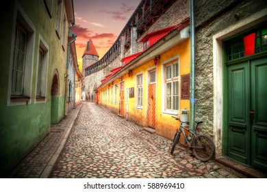 Bike On The Street. Old Streets Of European Cities. Cozy Cottages. Tallinn The Capital Of Estonia On The Baltic Sea.