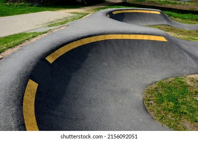 Bike Path In The Car Park Pumping (moving Up And Down) Is Used Instead Of Pedaling And Bouncing To Move Bicycles, Scooters, Skateboards And Inline Skates Along The Modular Pumptrack Track