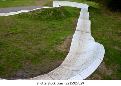 Bike Path In The Car Park Pumping Moving Up And Down Is Used Instead Of Pedaling And Bouncing To Move Bicycles, Scooters, Skateboards And Inline Skates Along The Modular Pumptrack Track