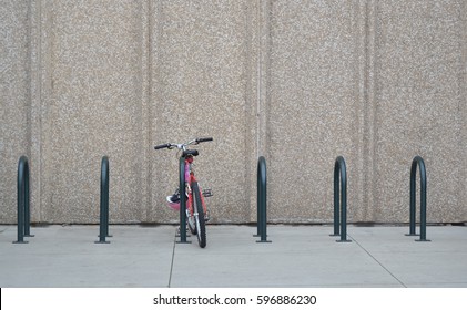 Bike Rack In Front Of Concrete Wall