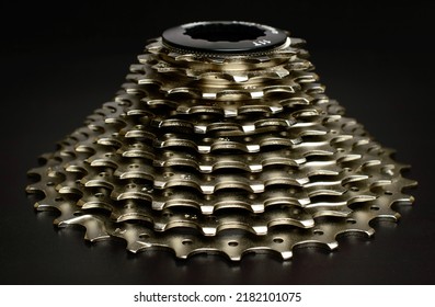 Bike rear cassette 11 speeds, bicycle spare parts, on a black background. Macro photo, selective focus.