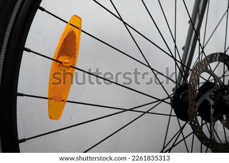 Bike reflector. Bicycle front wheel hub. Attachment of bicycle spokes. Safe driving.