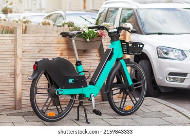 Bike Rent in City Street. Bicycle sharing service. Electric bike in urban environment. 
