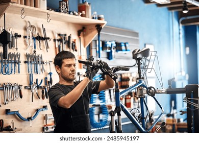 Bike repair, gears and maintenance with man in workshop for frame building or professional engineering. Assessment, bicycle and handlebars with mechanic or technician in startup for restoration - Powered by Shutterstock