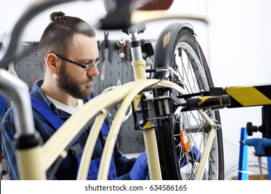 Bike Repair. The Man Repairs The Bike.