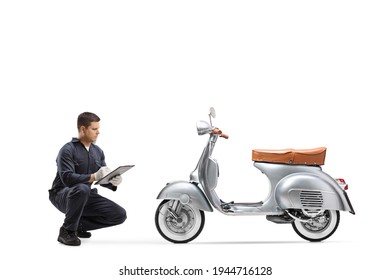 Bike repair mechanic kneeling in front of a vintage scooter isolated on white background - Powered by Shutterstock