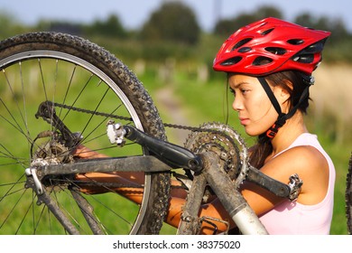 Bike Repair. Woman Repairing Mountain Bike.